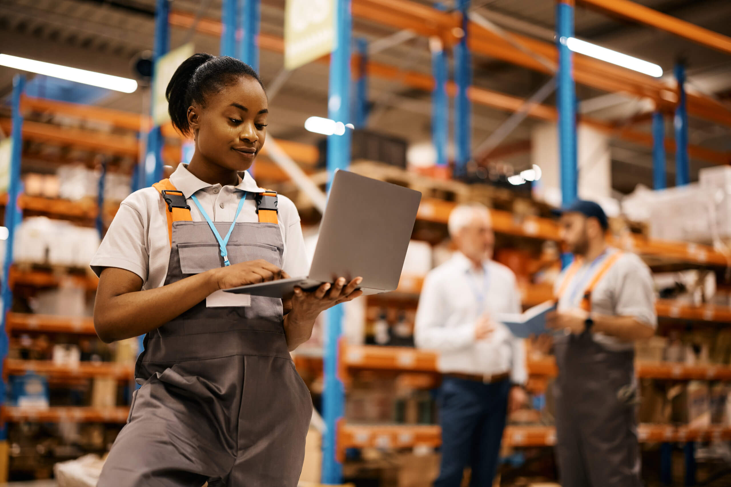 woman using laptop while working in warehouse