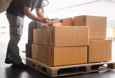 Warehouse worker holding clipboard his doing inventory managemen Warehouse worker holding clipboard his doing inventory managemen