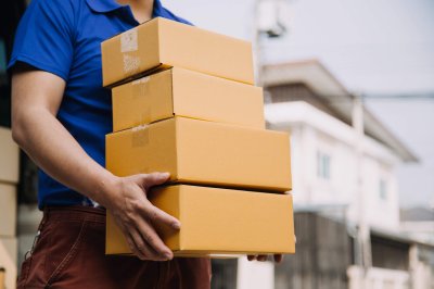 Business woman start up small business entrepreneur SME success .freelance woman working at home with Online Parcel delivery. SME and packaging deliveryconcept person holding corrugated box packaging type