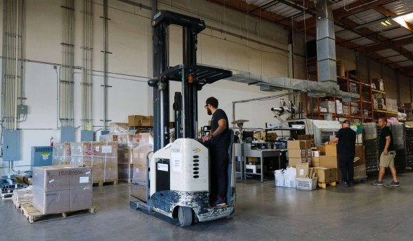 person on forklift in warehouse