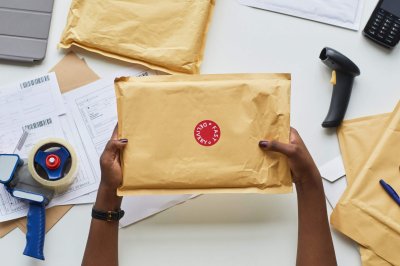 Postal Worker Shipping Parcel hands holding padded mailers